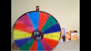 Hot blonde babe turns the wheel of fortune to spread sanilewan legs and masturbate